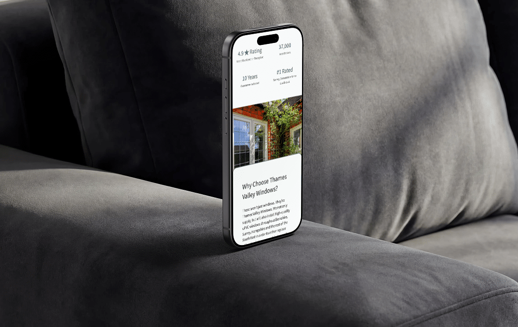 Thames Valley homepage displayed on a smartphone resting on a grey armchair