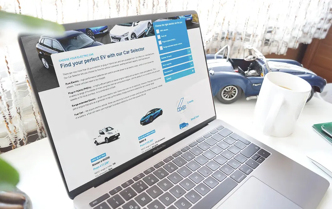 Automotive website displayed on a laptop with vehicle sales content