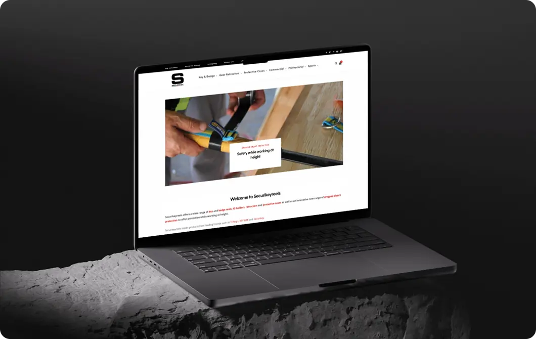 Website homepage with video content displayed on a laptop in a dark setting